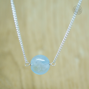 Aquamarine single gemstone delicate necklace on a diamond curb chain.